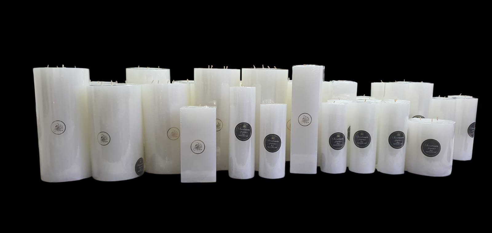 Elegant white label scented candles surrounded by floral arrangements, crafted by the best white label candle manufacturer in New Delhi